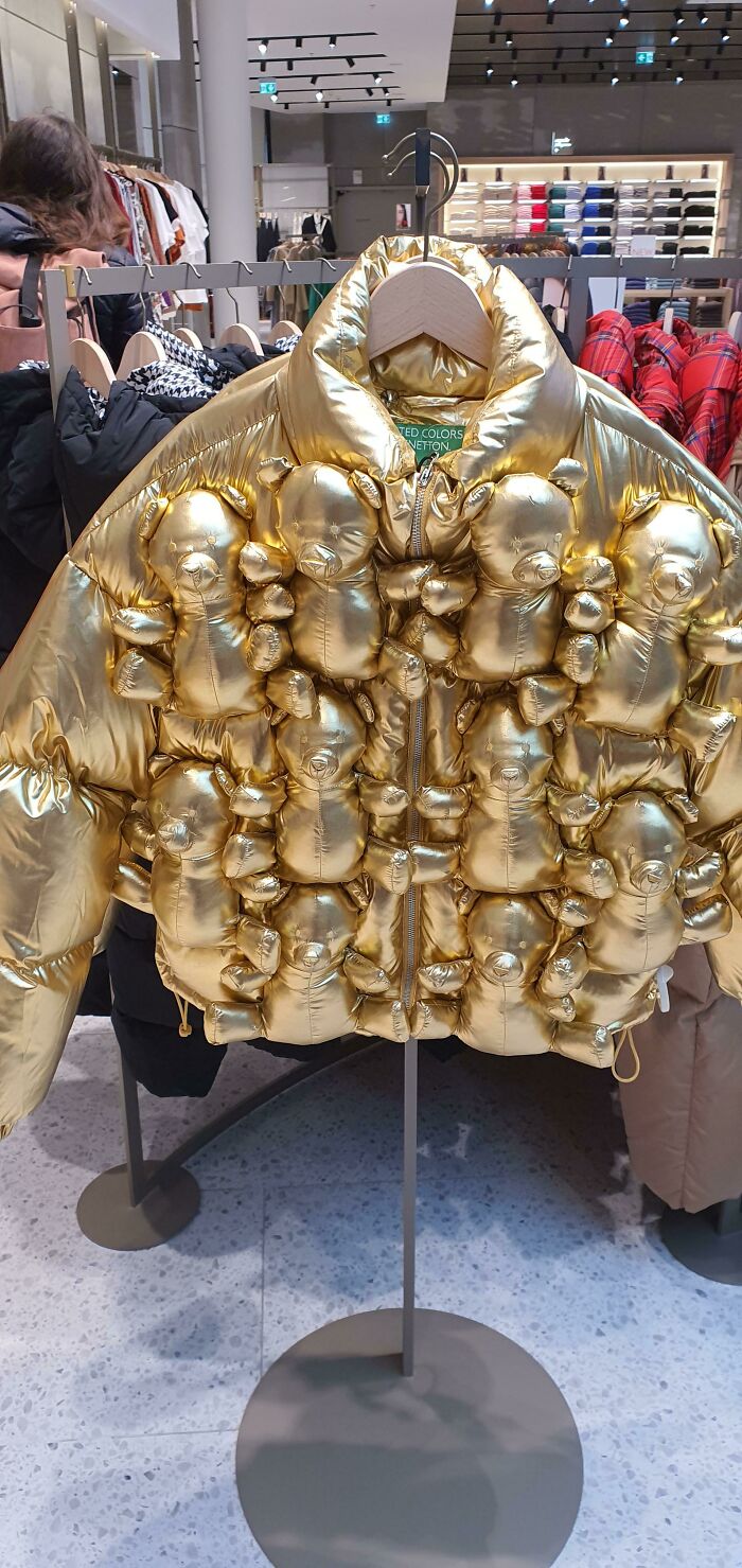 A shiny gold puffer jacket covered in small teddy bears, a hilariously bad fashion crime.