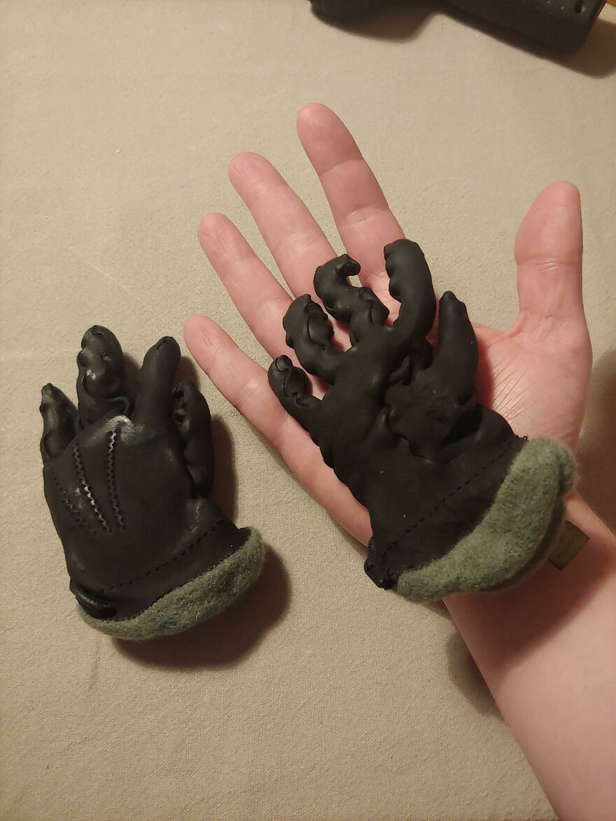 A hand holding up tiny, shrunken gloves, a funny and unfortunate fail.