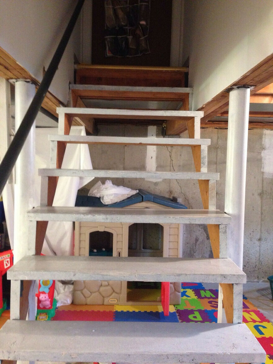 Stairs in a basement blocking a toy house, a funny unfortunate regret fail.