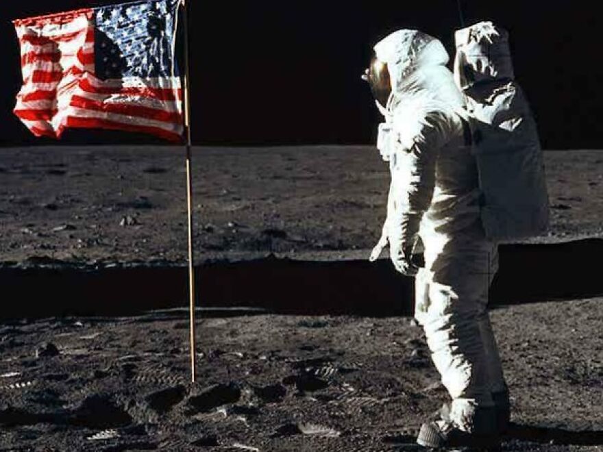 Astronaut on the moon with American flag. One of the strange things happening on Earth that look incredible.