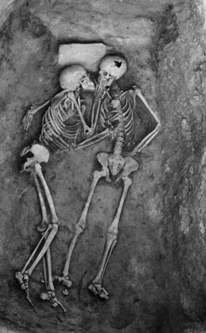 A historical photo of two skeletons embracing, representing an interesting, heartbreaking, and beautiful moment from history.