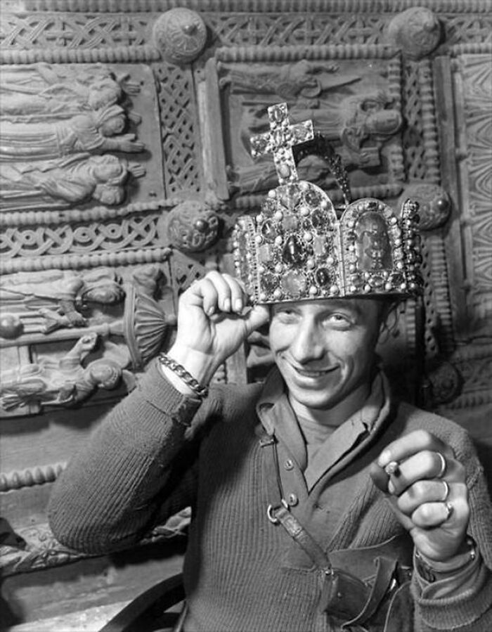Soldier wearing a bejeweled crown and smiling, an interesting historical photo.