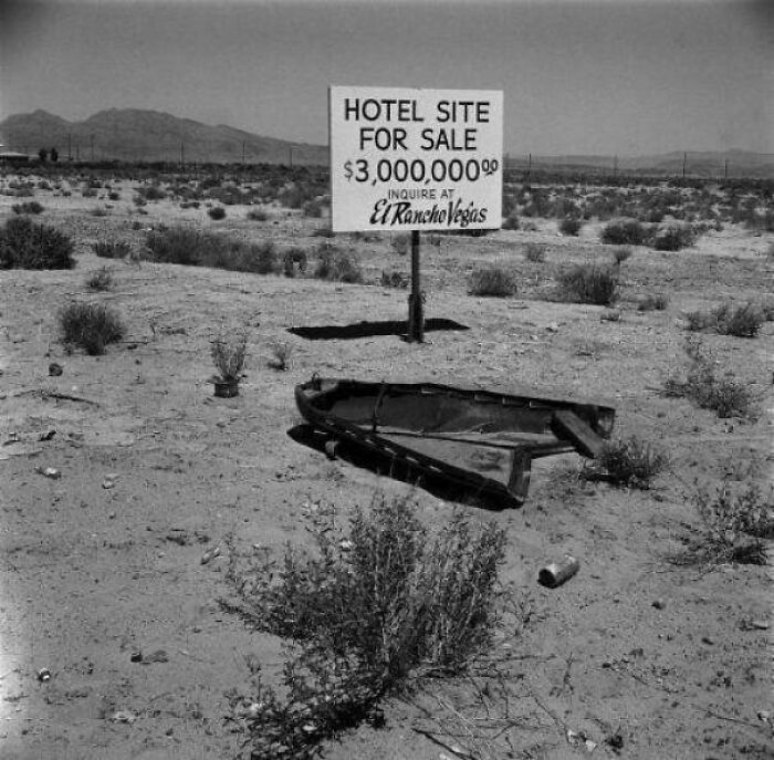 Interesting historical photo of a hotel site for sale sign in a desert, beautiful and desolate.