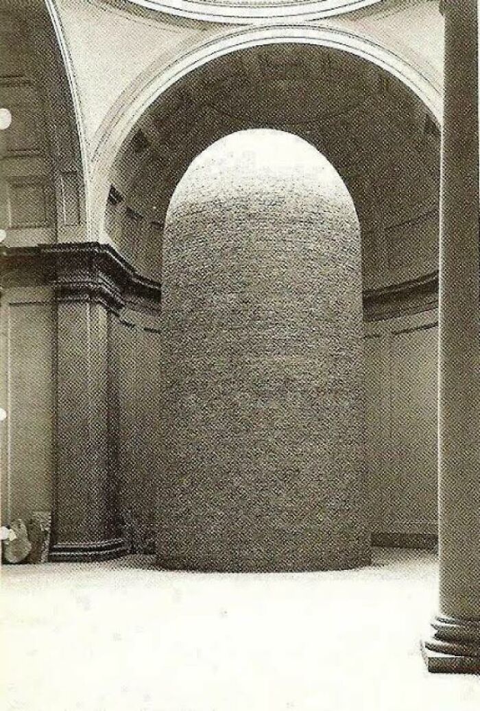 A beautiful photo from history of a large, cylindrical art installation in a grand hall.