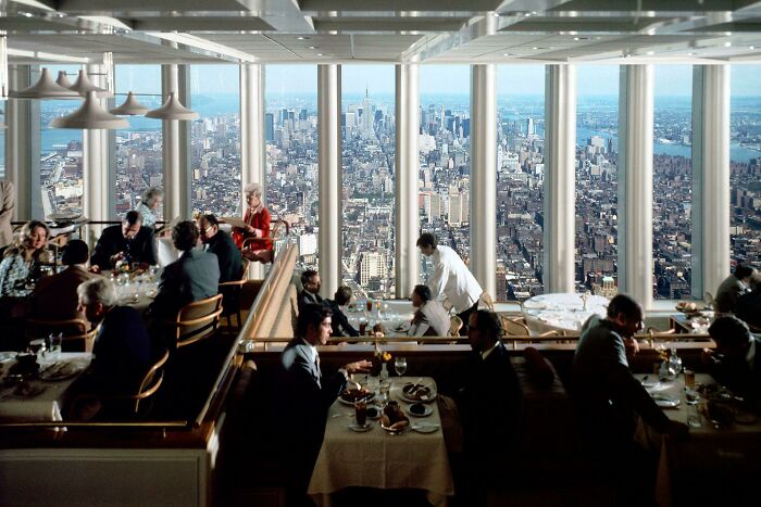 A restaurant with a panoramic view of the New York City skyline, a beautiful photo from history.