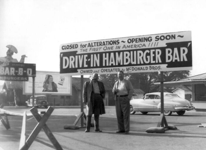 Two men standing in front of the first McDonald's Drive-In Hamburger Bar, an interesting photo from history.