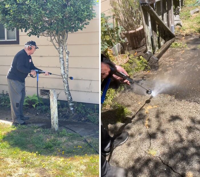 Person power washing dirt from a house exterior and a concrete path, making cleaning look fun.