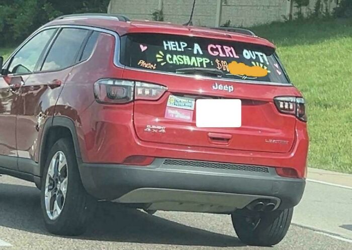 A red Jeep with an outrageous request written on its back window asking for money via CashApp, demonstrating a misunderstanding of how money works.