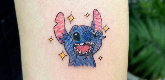 Stitch from Lilo & Stitch crayon drawing inspired tattoo on a person's arm.