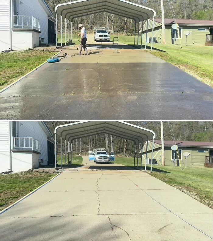 A person power washing a long concrete driveway under a carport, showing the satisfying clean result.