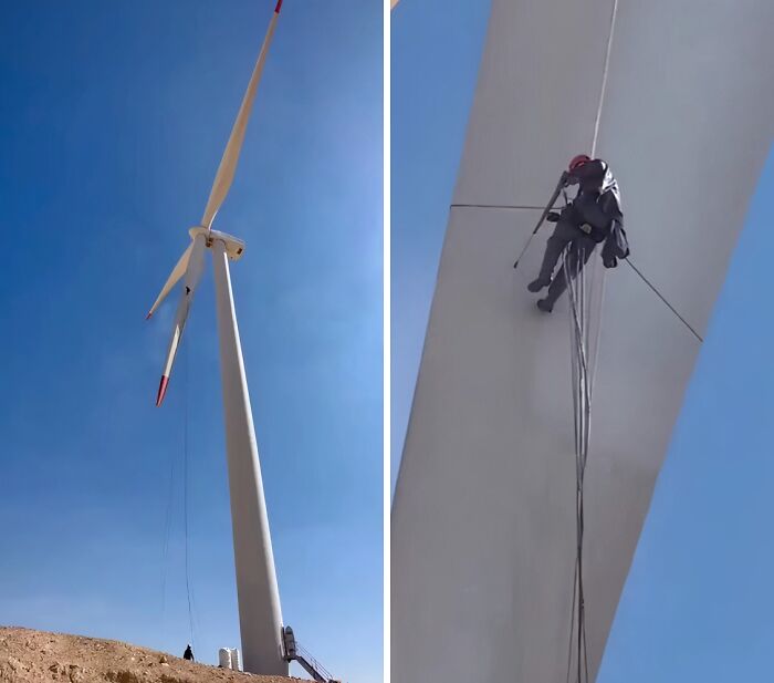 A worker rappelling down a wind turbine for maintenance, showing the process of power washing for satisfying cleaning.
