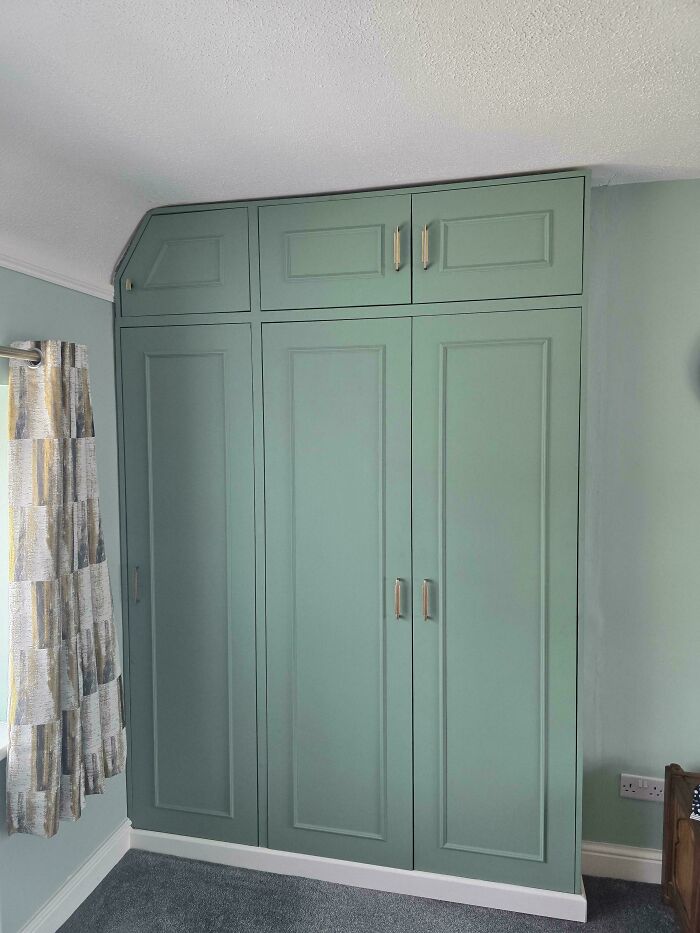 Custom-built, sage green wardrobes, showcasing people renovating their homes themselves.