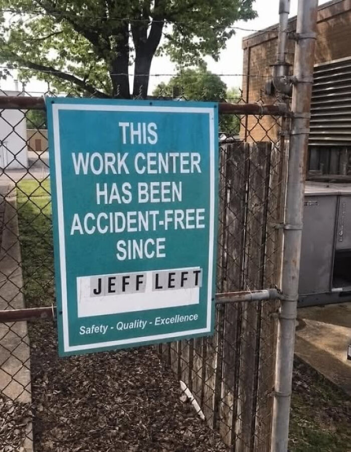 A sign on a fence declares a work center accident-free since Jeff left, a random joke.
