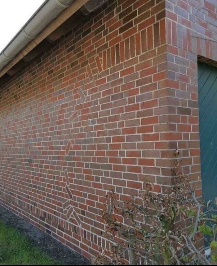 A unique brick wall design, demonstrating effort in home renovation with its detailed patterns and craftsmanship.