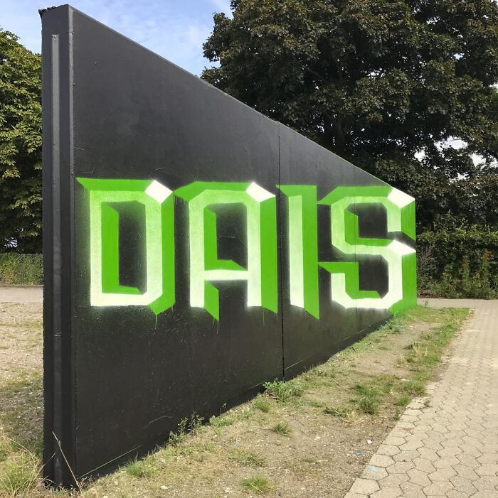DAIS graffiti in green and white on a black wall, one of many fascinating finds.