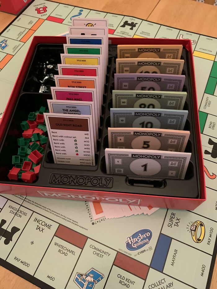 An open box of the Monopoly board game with money and cards neatly organized, a fascinating internet find.