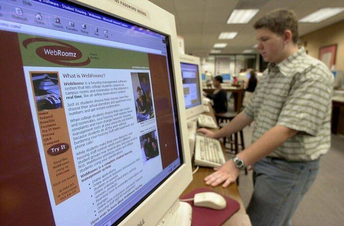 A person using an old computer with WebRoomz on screen, showcasing the old internet experience for today's kids.