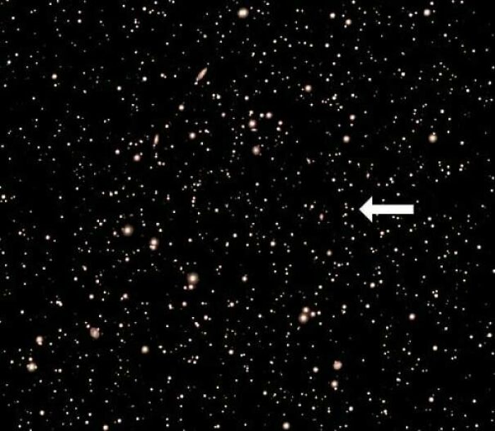 Fascinating finds: A vast starfield with countless celestial objects and an arrow pointing to one.