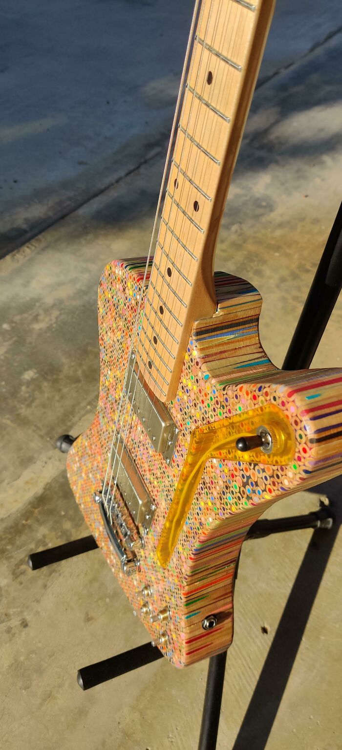 A unique electric guitar crafted from hundreds of colored pencils, showcasing fascinating finds from the internet.