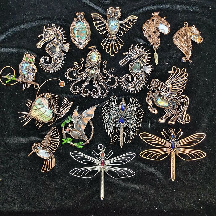 A collection of handmade projects featuring intricate wire-wrapped jewelry pieces depicting various animals and insects.