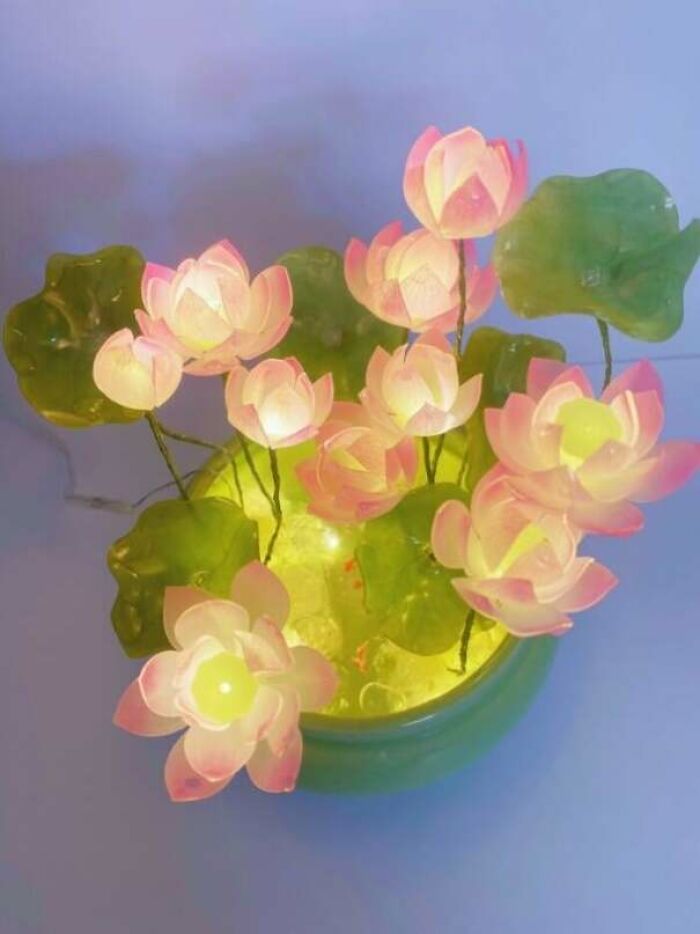 A delicate arrangement of glowing pink lotus flowers, a beautiful example of handmade projects.