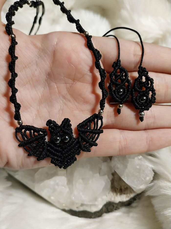 Close-up of a handmade macrame bat necklace and matching earrings, showcasing unique handmade projects.