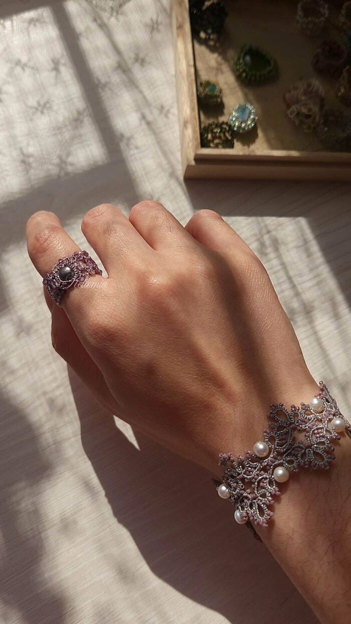 A hand adorned with a delicate handmade lace ring and bracelet, featuring intricate handmade projects.