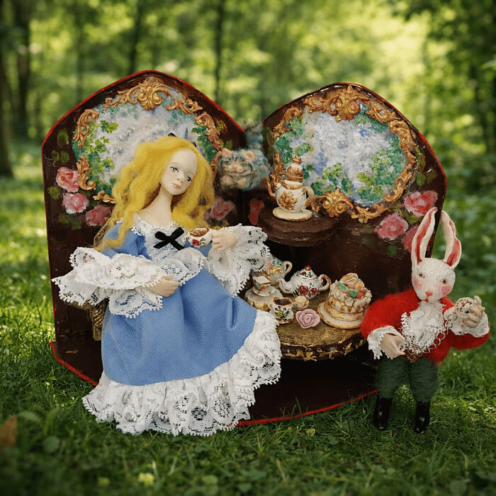 A handmade projects doll display of Alice and the White Rabbit having a tea party in a forest setting.