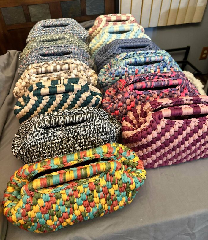A collection of colorful, patterned handmade woven bags, showcasing various handcrafted projects.