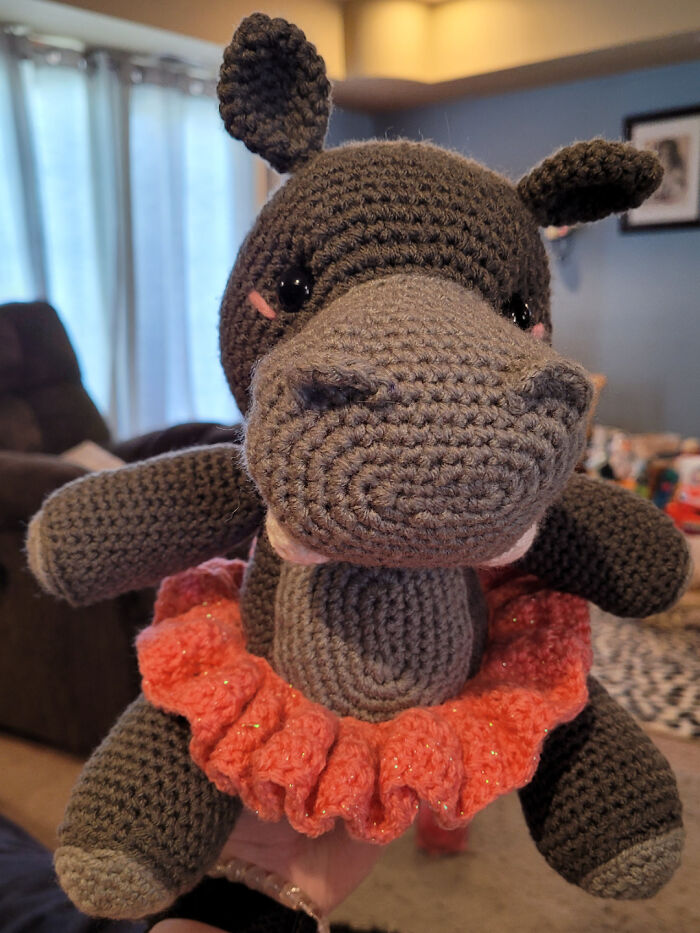 Adorable crocheted hippo doll wearing a pink tutu, a charming handmade project.