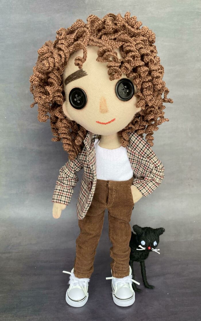 Unique handmade projects: a fabric doll with curly brown hair, wearing a plaid jacket, corduroy pants, and white sneakers.