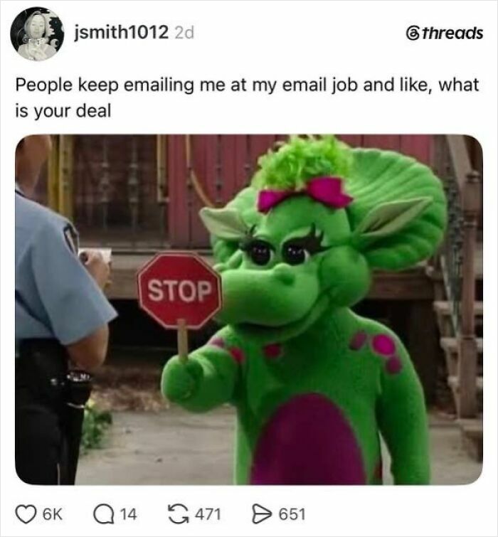 A social media post featuring a Barney character holding a stop sign, humorously complaining about emails at an email job, capturing the absurdity of having a job.