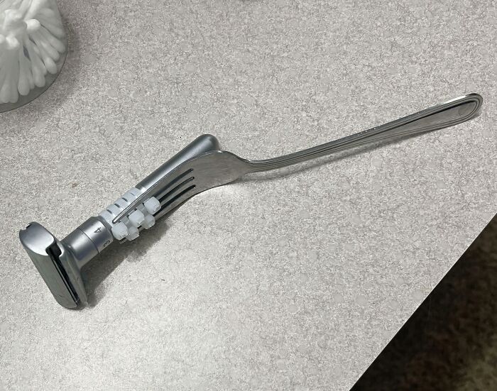 Clever solution: A fork attached to a device on a counter, displaying ingenuity with random junk.