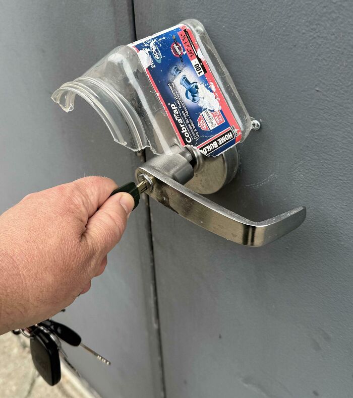 Clever solution: A plastic container over a door handle for protection, showing a clever use of random junk.