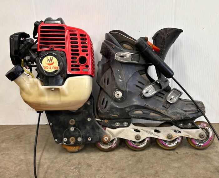 A black inline skate with a small red engine attached. A clever solution turning random junk into a unique ride.