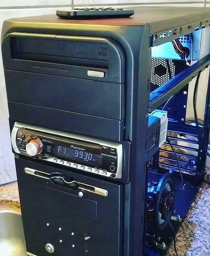 A black computer tower with a car stereo and DVD drive, a clever solution from random junk.