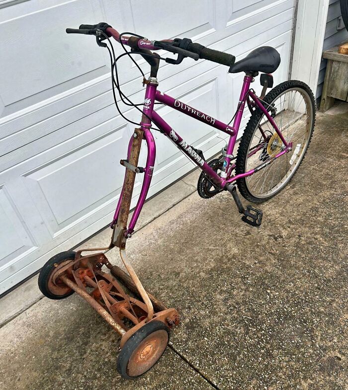 A bicycle modified into a lawnmower, showing clever solutions for junk.