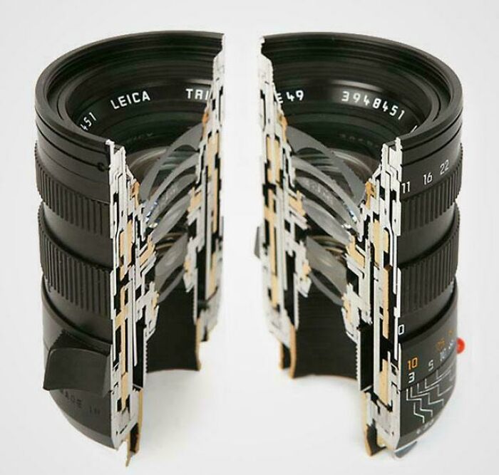 A surprising photo of a Leica camera lens cut in half, showcasing its complex optical elements and internal design.