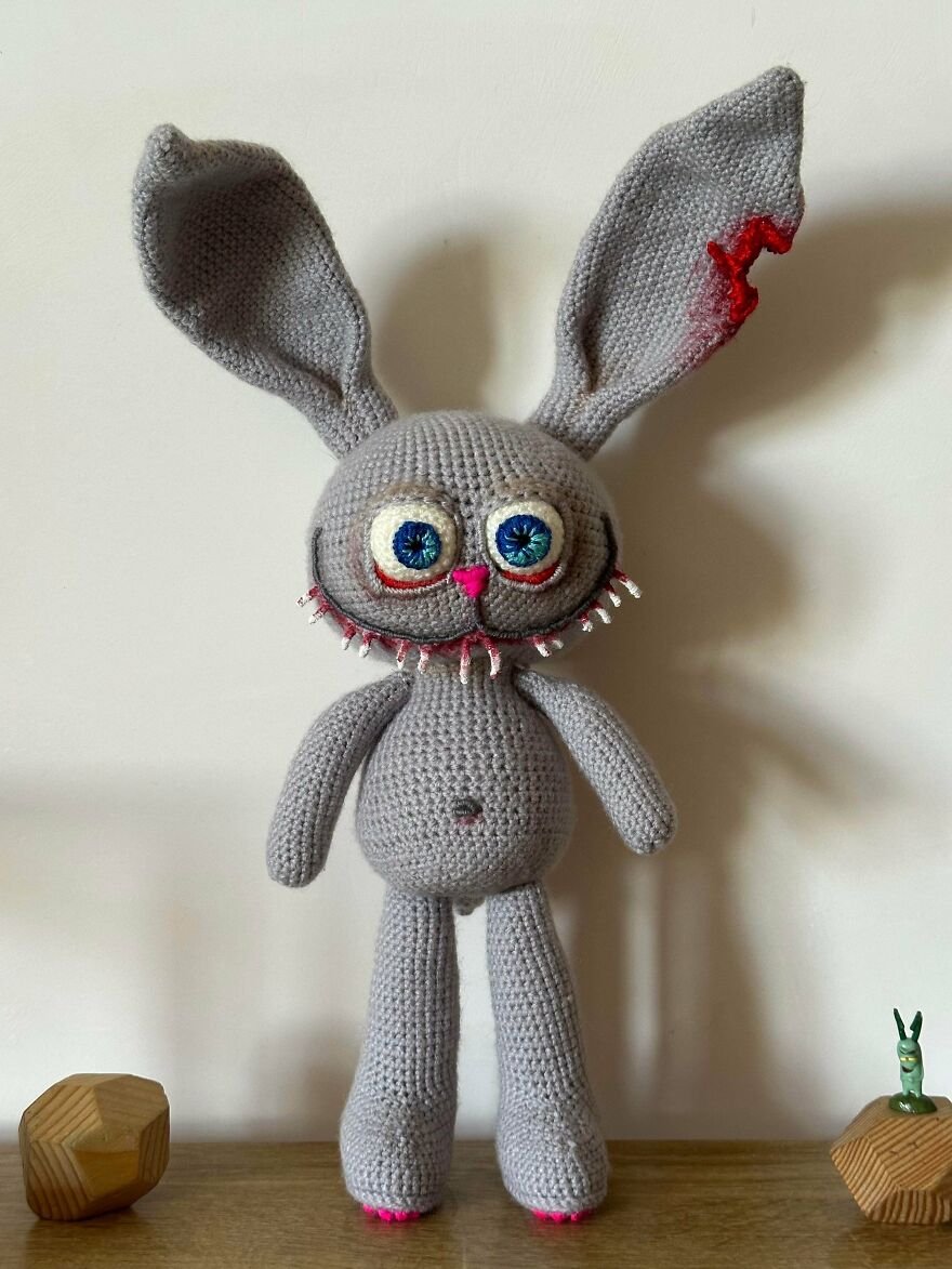 A creepy crochet creation bunny with bloodshot eyes and red accents on its ears, proving craft projects are unique.