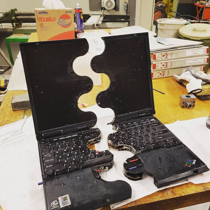 Two laptops cut in half with a jigsaw pattern, designed to interlock like puzzle pieces, surprising photos of objects.