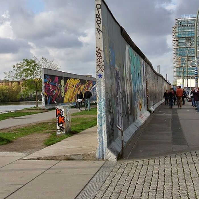Interesting photo of the Berlin Wall, a historical object cut in half virtually, showing its former divide.
