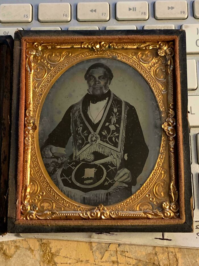 An old framed photo of a man in formal attire found while exploring abandoned places.