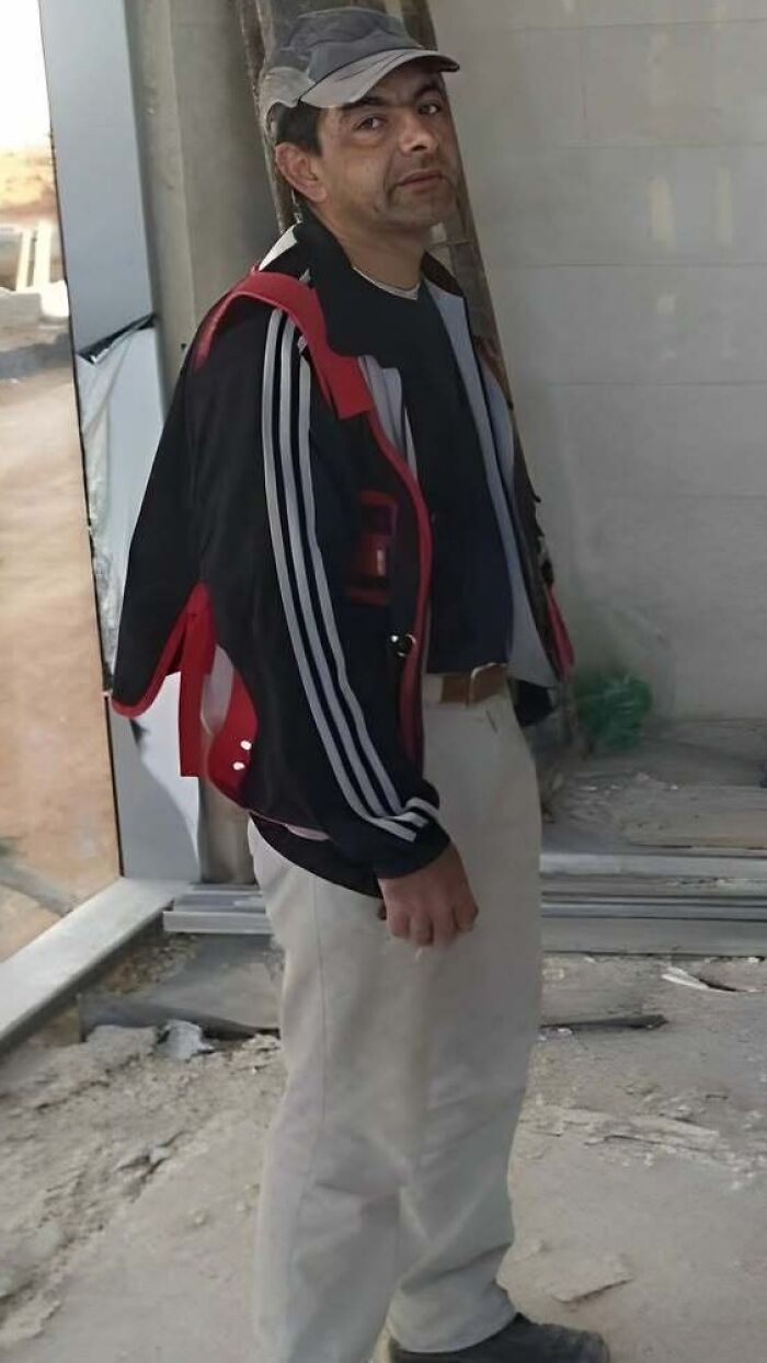 A man from Eastern Europe standing indoors, showcasing how people are built different.