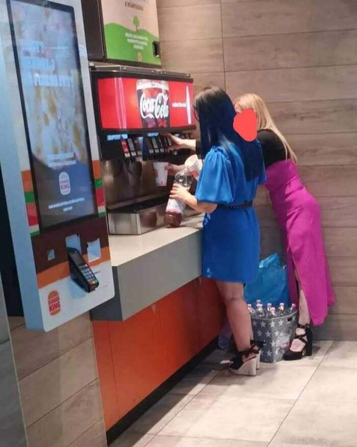 Women refilling drinks in a fast-food restaurant in Eastern Europe, demonstrating why people are built different.
