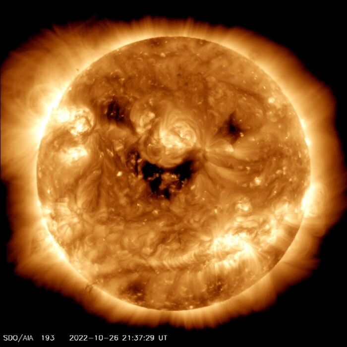 Wholesome image of the Sun showing a smiling face made of active regions in ultraviolet light.