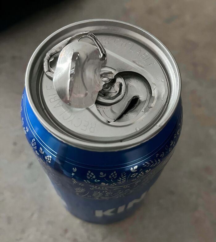 A baffling image of a partially opened soda can with a broken tab, sparking questions.