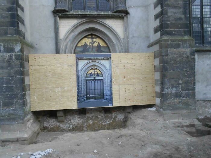 A construction barrier with a photo of the original entrance, part of people's trips that didn't go as planned.