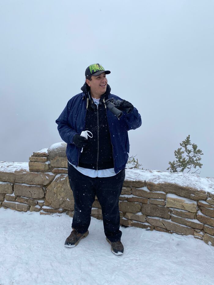 A man standing in the snow, smiling, the trips didn't go as planned