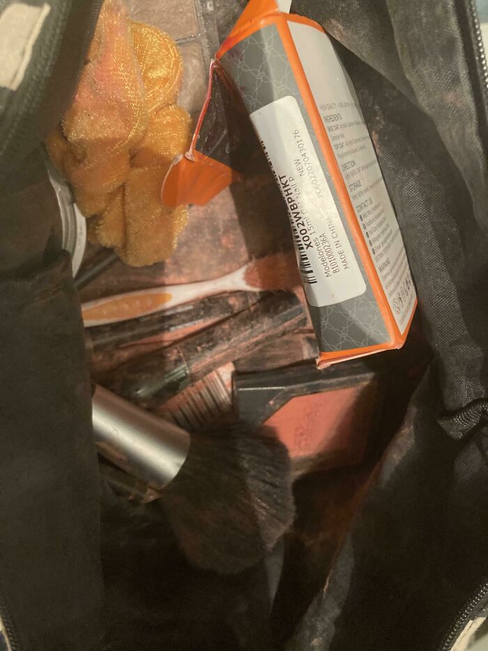 A makeup bag with various items, some spilled, representing potential travel trip issues.
