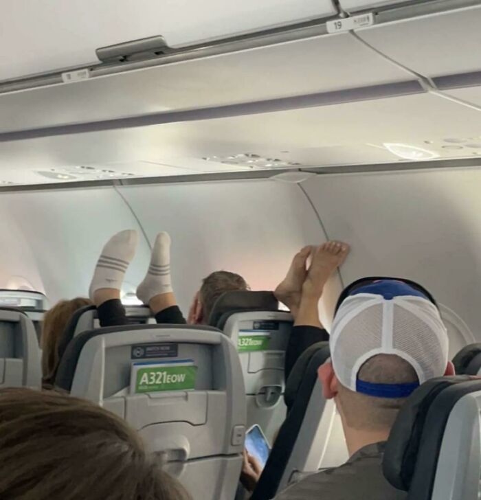 Passengers on a plane with their bare feet up on the seats, making for unpleasant trips.